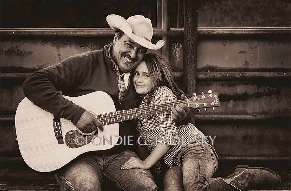 Father making music with  his guitar and daughter alongside.  Central Coast, California.      ©Londie G. Padelsky RDUPG14_236_LondieGPadelsky