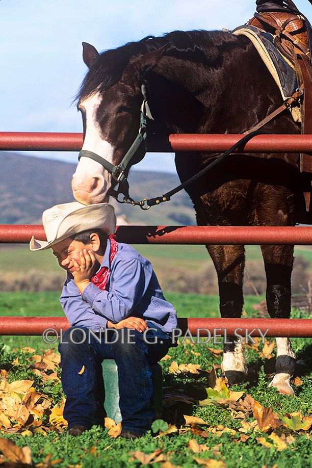 Little cowboys horse nibbles on cowboy hat.                                   ©Londie G. Padelsky SLC-6770_LondieGPadelsky