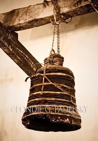 Rare wooden bell carved out of two-foot blocks of wood that was used during Holy Week when the metal bells were silent. Historic California Mission ©Londie G. Padelsky CCM-541_LondieGPadelsky