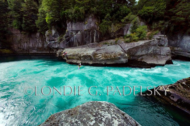 Kayakers diving off rock edge into the Futalefu River, Los Lagos Region, Patagonia, Chile, South America ©Londie G. Padelsky 11SAC_LGP7615_LondieGPadelsky