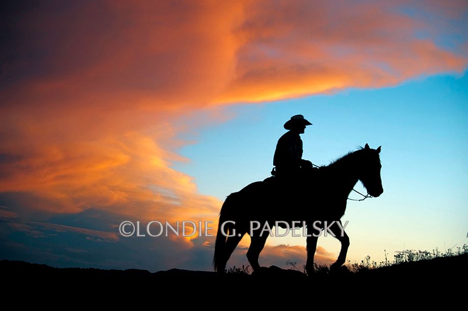 Cowboy riding horseback at sunset. ©Londie G. Padelsky _LGP0107_LondieGPadelsky