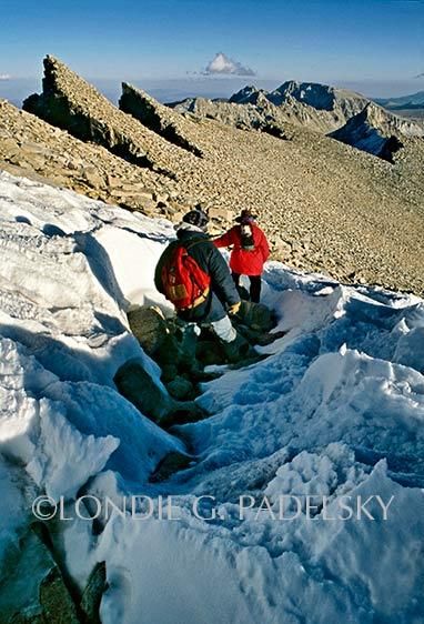 Two people hiking in snow near the top of Mount Whitney, the highest summit in the contiguous United States and the Sierra Nevada, California ©Londie Garcia Padelsky JMT-3553_LondieGPadelsky
