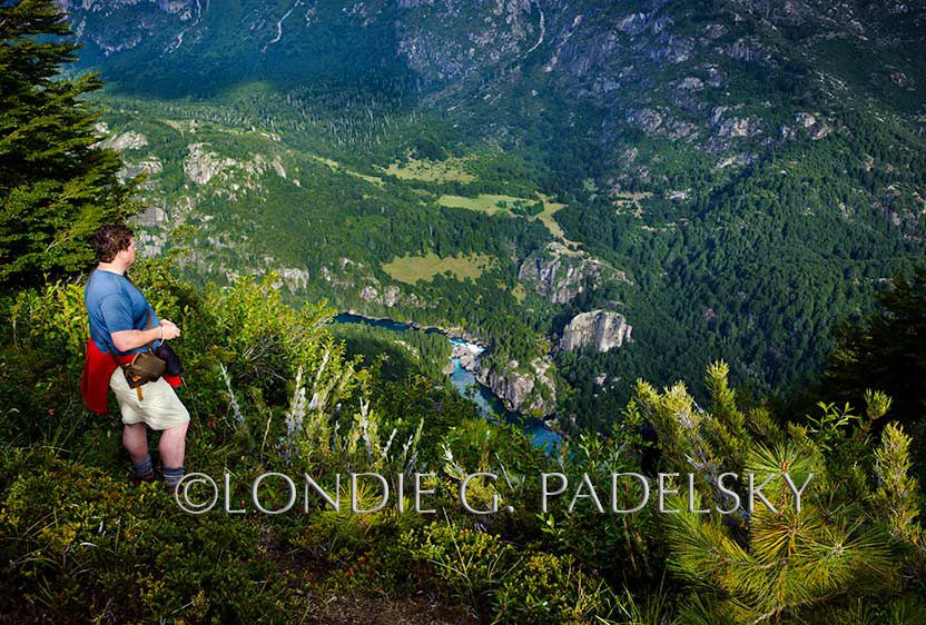 From Condor Mountain-a hiker looks down on Cave Camp and Knife's Edge climbing rock from Tree House Camp, Futalefu River, Los Lagos Region, Patagonia, Chile, South America ©Londie G. Padelsky 11SAC_LGP3978_LondieGPadelsky