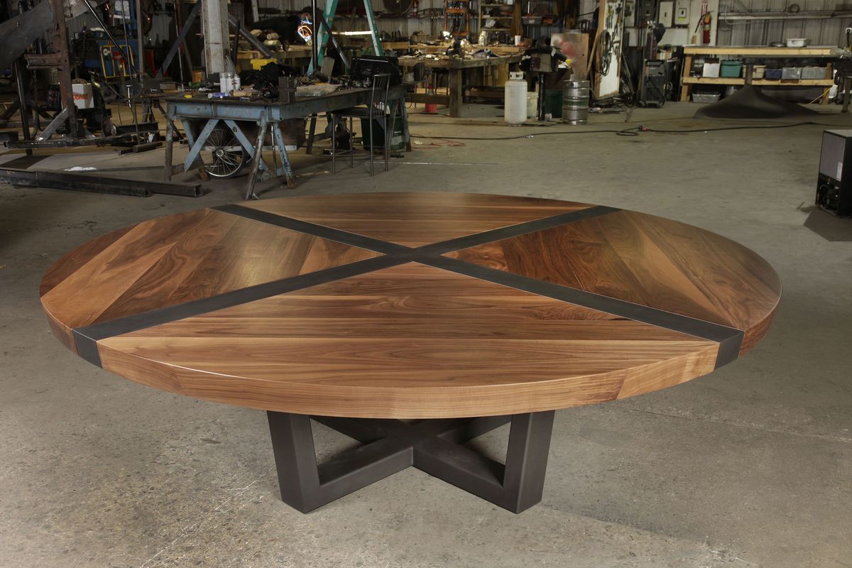 Walnut top with patina steel top and base.  92" Diam. x 30"h.  Available in a wide array of woods, finish options, and custom sizes. Tupelo table