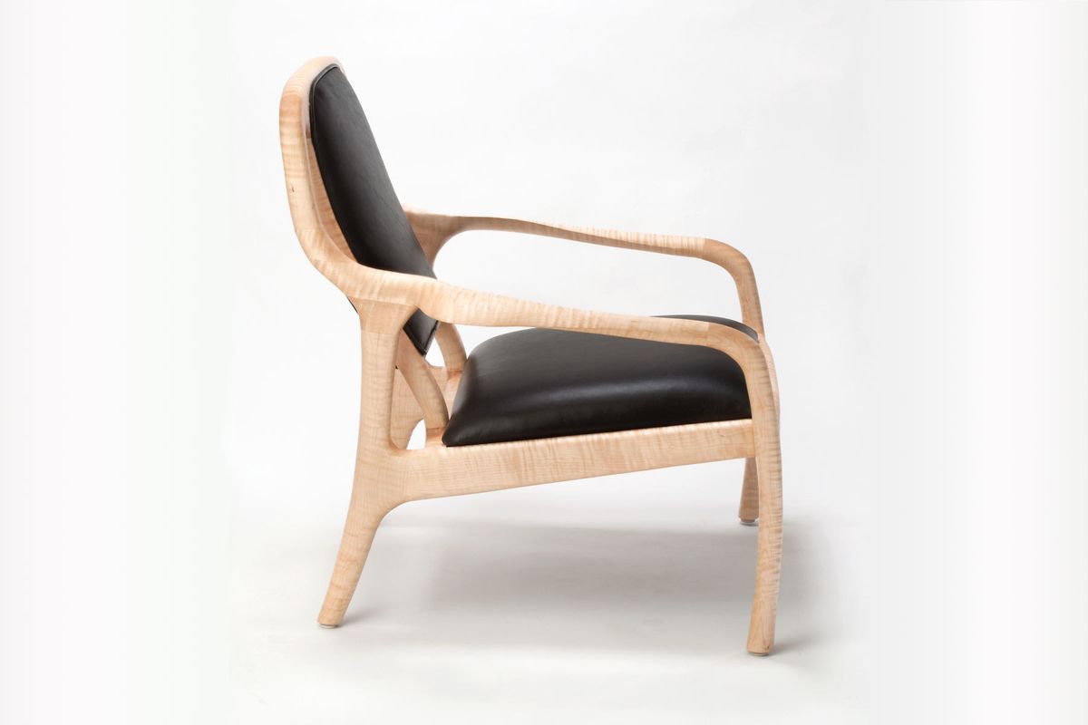 Shown in figured maple with black leather upholstery.  29" wide x 29" deep x 32" tall.  Available in a wide array of woods and upholstery. Karnali lounge chair