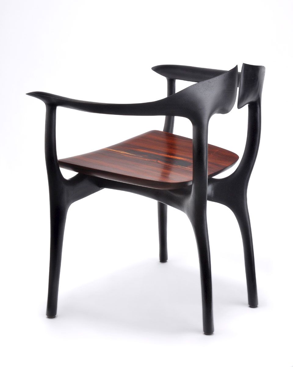 Shown with ebonized walnut frame and cocobollo seat. Swallowtail chair