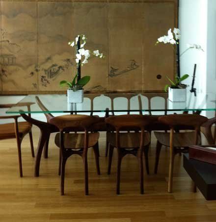 Shown in walnut with accompanying Swallowtail and  Gentian chairs, also in walnut.  Supporting glass top.  96"l x 40"w x 30"h.  Available in a wide array of woods and finish options. Thistle table