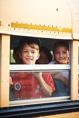 School bus window, kids looking out