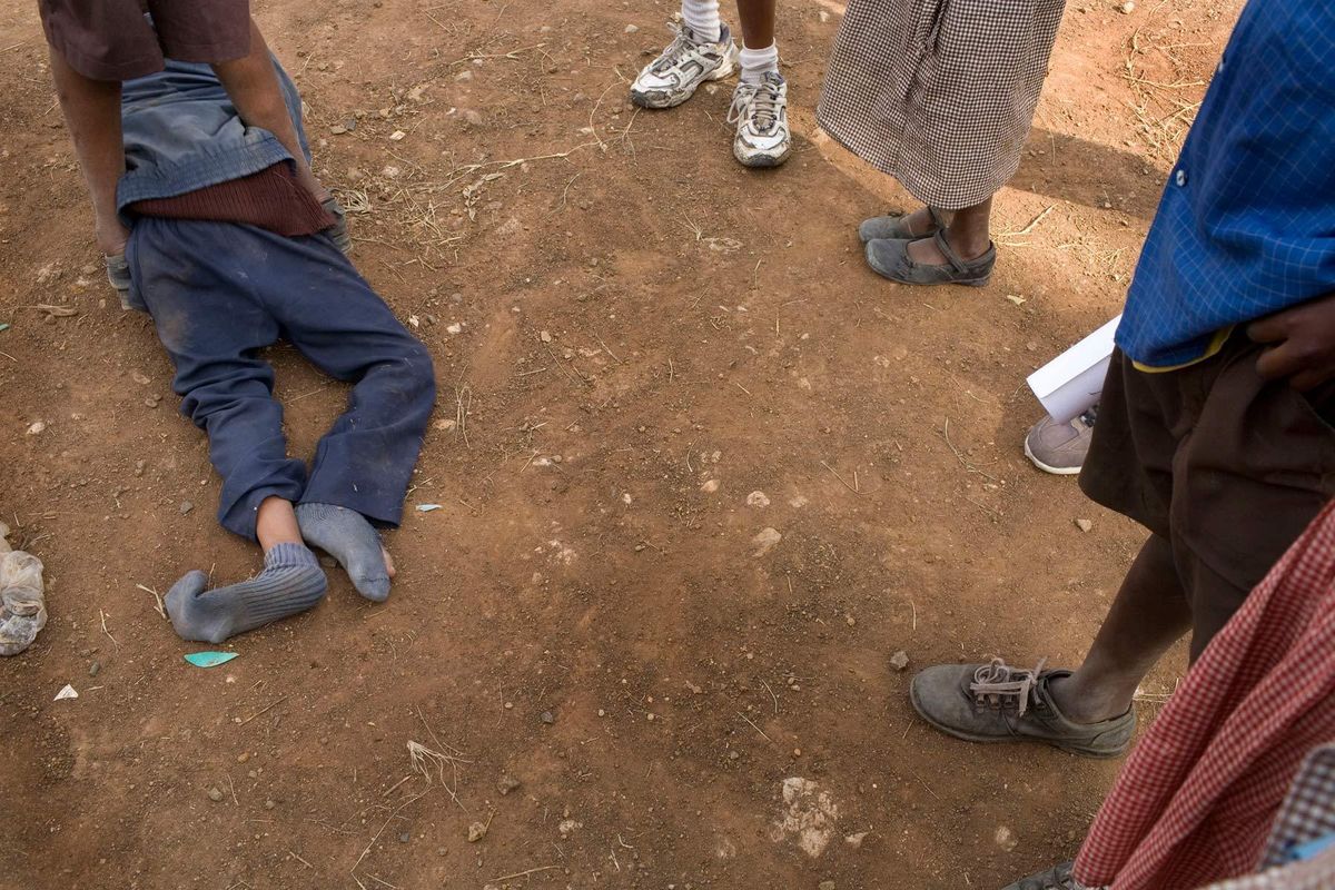 Mutava, protectively standing over Braise as they play with other Classmates at school before lessons.© Hazel Thompson Carried on friendship