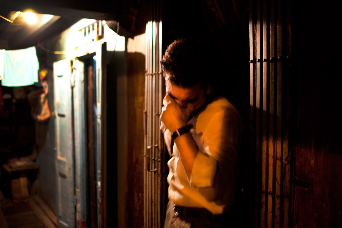 A customer hides his face as he leaves a brothel on 14th Lane.© Hazel Thompson Mumbai's Gangsters and Sex Slaves