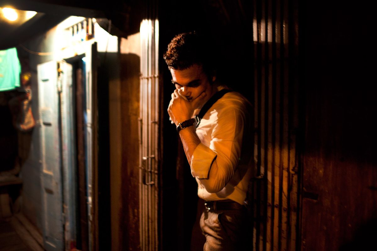 A customer hides his face as he leaves a brothel on 14th Lane.© Hazel Thompson Mumbai's Gangsters & Sex Slaves
