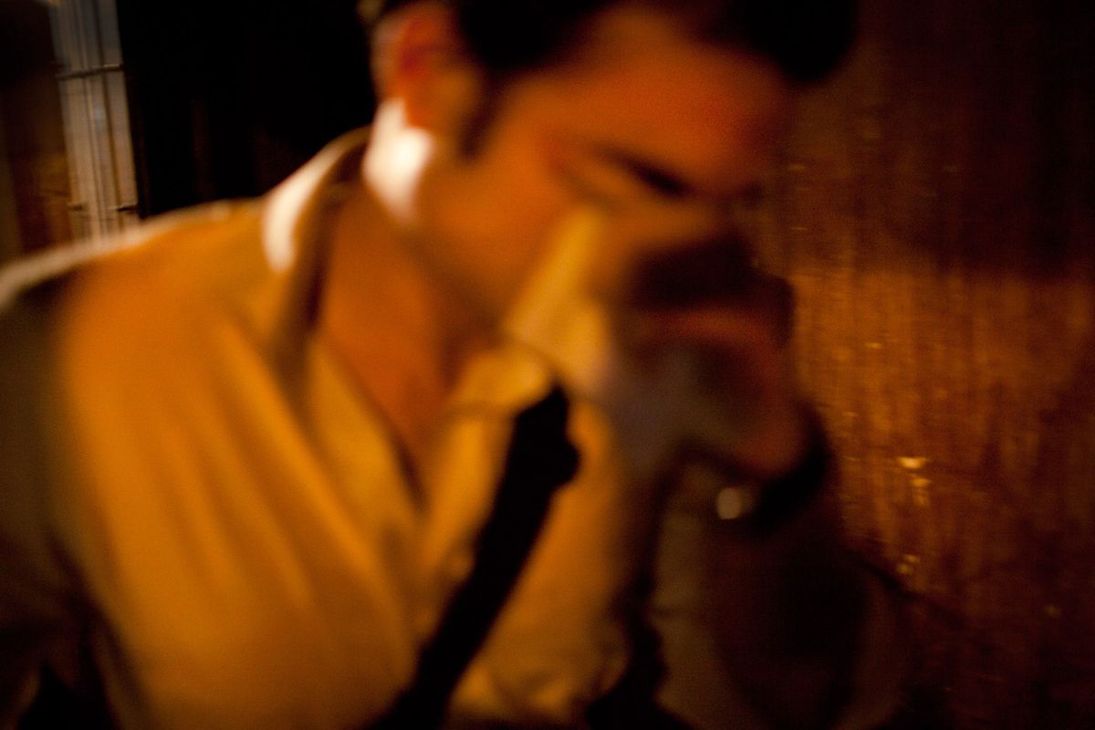 A customer hides his face as he leaves a brothel on 14th Lane.© Hazel Thompson Mumbai's Gangsters & Sex Slaves