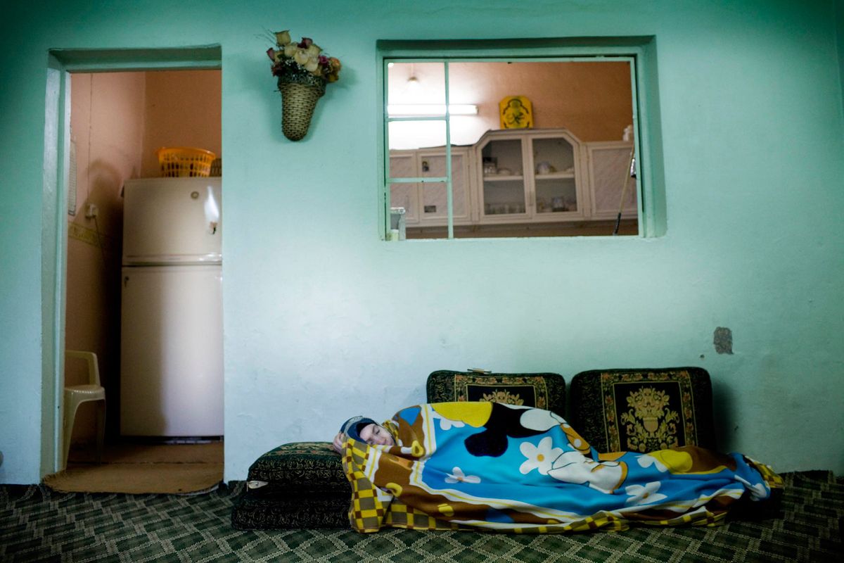 Bibi, aged 70 a widow and mother of 6 children, taking an afternoon nap in her front room.© Hazel Thompson Measure of a Woman