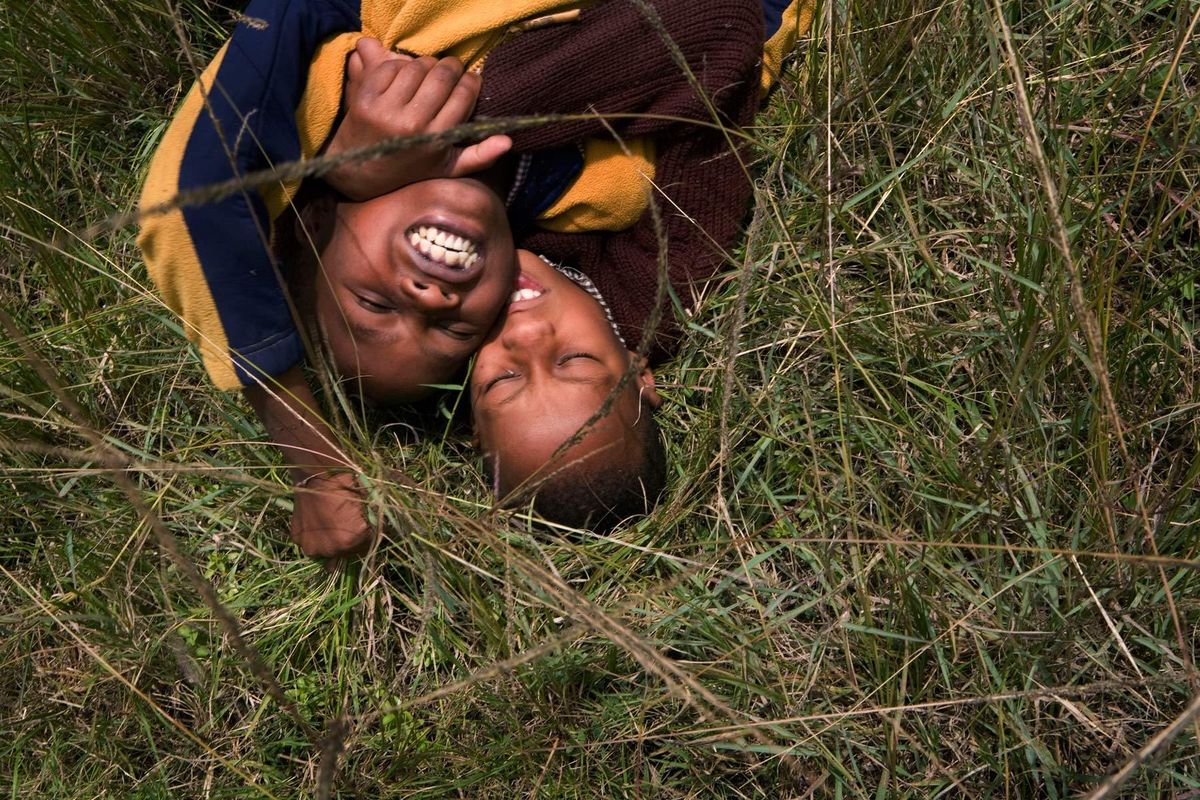 Mutava and Braise play fighting in the playing field next to the school at playtime.© Hazel Thompson Carried on friendship