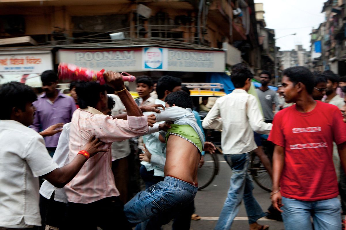 A gang fight breaks out on 14th Lane in broad daylight on the busiest day of the week for the sex trade, a Sunday. Pimps and gangsters chase and beat up a rival gang pimp for being drunk and rude. Later that night, the victim retaliated with his gang. Two men ended up in hospital with life threatening injuries. © Hazel Thompson Mumbai's Gangsters & Sex Slaves