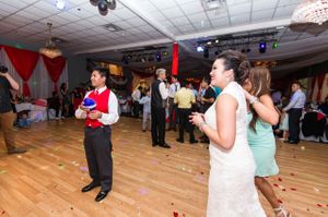 Bride Watches As Groom Prepares For Garter Toss Reception