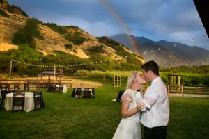 Hoopes Events | Tori and Sterling | Quiet Meadow Farms | Mapleton Utah | Bride and Groom Kissing in Front of Rainbow After Downpour Tori_Sterling_Quiet_Meadow_Farms_Mapleton_Utah_Bride_Groom_Kissing_in_Front_of_Rainbow.jpg