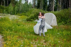 Ashley_Dan_Solitude_Resort_Solitude_Utah_Bride_Groom_Embracing_in_Mountain_Field_with_Mountain_Flowers.jpg