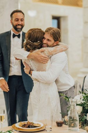 Bride hugs guests after ceremony Reception