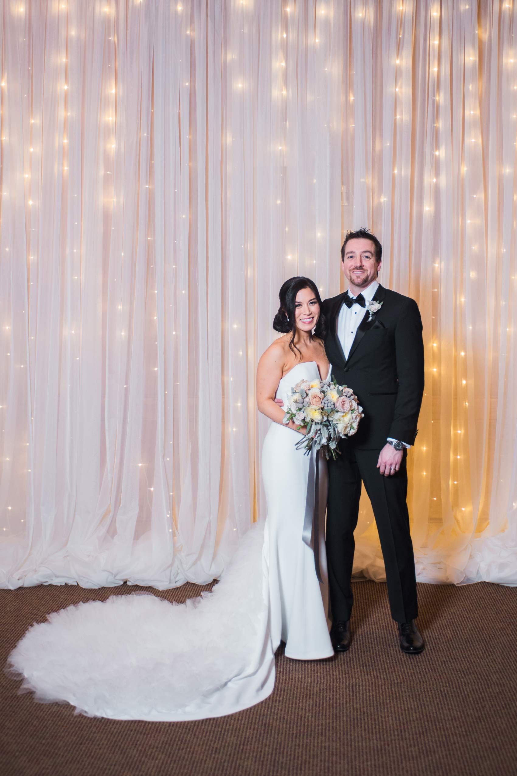 Julia_Mark_Silver_Lake_Lodge_Deer_Valley_Resort_Park_City_Utah_Bride_Groom_In_Front_Of_Shimmering_Backdrop.jpg