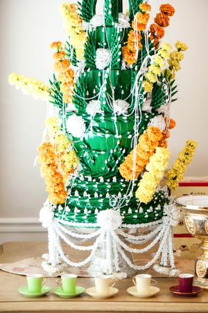 Orange and Yellow Flowers On Green Tower Used For Ceremony Details