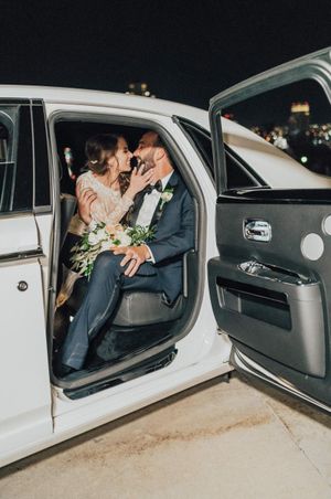 Bride and groom leave in white limo Send Off