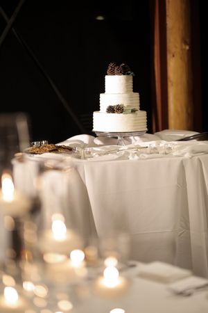 Wedding Cake with Soft Candles in Foreground Wedding Cake