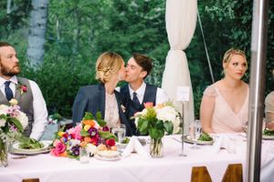 Hoopes Events | Claire and Scott | Millcreek Inn | Bride and Groom Kissing at Head Table | Salt Lake City Utah | Vivid Floral Centerpiece Claire_Scott_Millcreek_Inn_Salt_Lake_City_Utah_Bride_Groom_Kissing_Head_Table.jpg