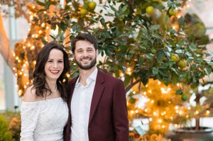 Couple with Lighted Trees in Background Rehearsal Dinner