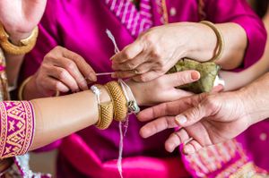 Bride Gets Help Putting On Bracelets Pre-Ceremony