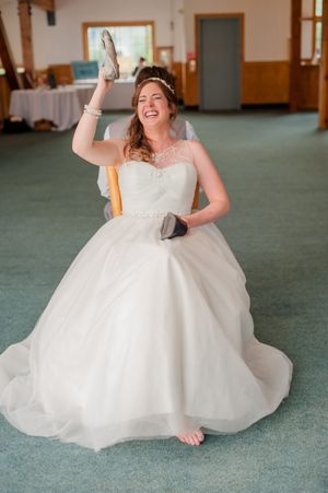Hoopes Events | Ashley and Dan | Solitude Resort | Solitude Utah | Reception | Bride Answering Question With Shoe During Quiz Ashley_Dan_Solitude_Resort_Solitude_Utah_Bride_Answering_Question_With_Shoe_During_Reception_Quiz.jpg
