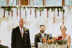 Bride and Groom at the Head Table with "You Are the Best Thing" backdrop Reception