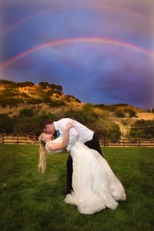 Hoopes Events | Tori and Sterling | Quiet Meadow Farms | Mapleton Utah | Bride and Groom Kiss with Double Rainbow in the Background | It's Good Luck When it Rains on Your Wedding Tori_Sterling_Quiet_Meadow_Farms_Mapleton_Utah_Bride_Groom_Kissing_Double_Rainbow.jpg
