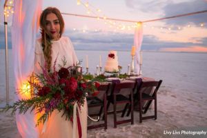 Salt_Air_Wedding_Shoot_Saltair_Resort_Salt_Lake_City_Utah_Elegant_Table_Setting_Candlelit_Head_Table_Bride_Holding_Bouquet.jpg