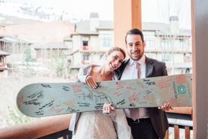 Ilana_Dave_Canyons_Resort_Park_City_Utah_Bride_Groom_Show_Off_Signed_Skiboard_Before_Skiing_and_Boarding.jpg