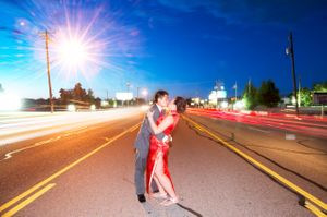 Bride and Groom Kiss In the Middle of the Street Among Passing Cars Bride and Groom