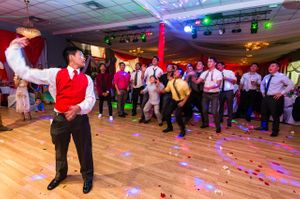Groom Tosses the Garter To Group Of Single Men Reception