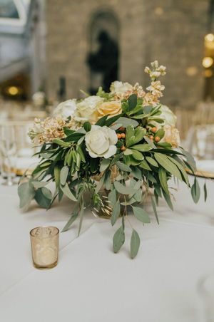 Flower centerpiece with roses, stock, and berries Reception Details