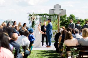 Hoopes Events | Tessa and Taani | Utah State Capitol | Salt Lake City Utah | Ceremony | Bride and Groom in Front of Backdrop with Hanging Pineapples Tessa_Taani_Utah_State_Capitol_Salt_Lake_City_Utah_Ceremony_in_Front_of_Pineapple_Draped_Backdrop.jpg