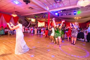 Bride Tossing Bouquet To Wedding Guest Reception