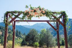 Kristin_Haven_Blacksmith_Fork_Canyon_Hyrum_Utah_Flower_Draped_Wooden_Arch.jpg