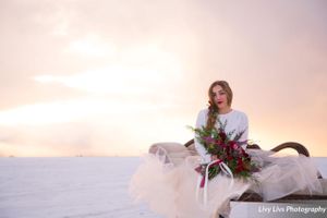 Salt_Air_Wedding_Shoot_Saltair_Resort_Salt_Lake_City_Utah_Sun_Shining_Through_Clouds_Bride_on_Swan_Fainting_Couch.jpg