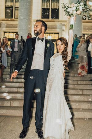 Bride celebrates with bouquet in the air during send off Send Off