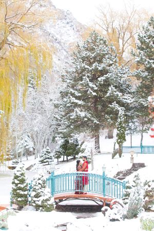 Bride in Burgundy Dress with a Snowy Backdrop Pre-Ceremony