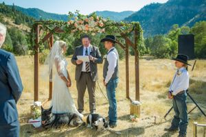 Hoopes Events | Kristin and Haven | Blacksmith Fork Canyon | Hyrum Utah | Wedding Ceremony in Front of a Wood Arch Adorned with Pale Flowers Kristin_Haven_Blacksmith_Fork_Canyon_Hyrum_Utah_Wedding_Ceremony_Wood_Arch_Background.jpg