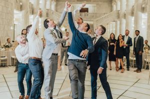 Men go in for the garter toss Reception
