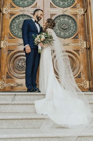 Bride and groom stand outside temple doors Bride and Groom