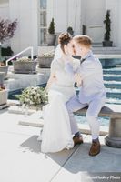 Lexie_Neil_Utah_State_Capitol_Salt_Lake_City_Utah_Bride_Groom_Kissing_on_Bench_By_Fountain.jpg
