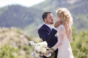 Bride and Groom Sharing a Tender Moment With a Stunning Mountain Backdrop Pre-Ceremony