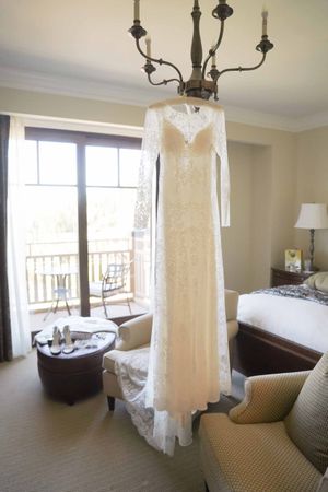 Bride's Dress Hanging From Chandelier Details
